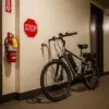 electric bike charging indoors with visible battery safety concerns