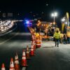 Nighttime highway work zone showing accident prevention and traffic safety risks