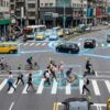 AI near-miss detection system monitoring vehicles, cyclists, and pedestrians at a busy urban intersection